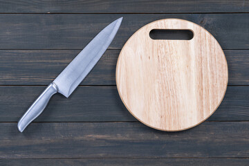 Close up kitchen knife and wooden round cutting board