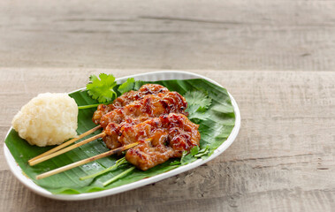 Pork skewers grilled on banana leaves