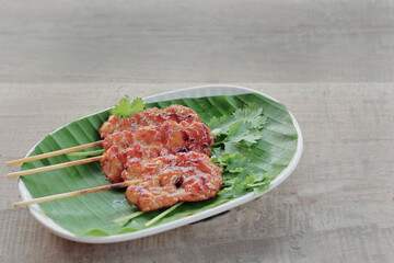 Pork skewers grilled on banana leaves