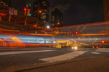 Long exposure motion shot. Night streets of New York city. Red light glowing traces