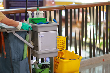 The cleaning staff car in the mall cleans the floor and a lot of cleaning supplies in it.