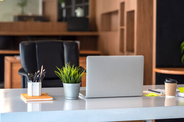 Front view on the desk in the office there are working equipment place.