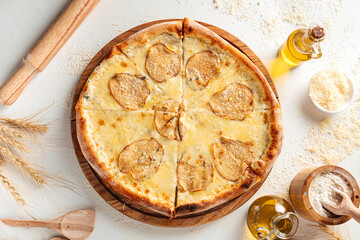 Top view on dorblu cheese pizza with pears on the white decorated background