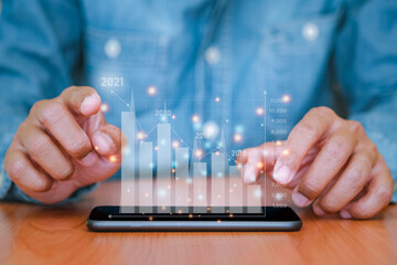 Businessman use a smartphone to analysing with financial graph data. Business finance background. business finance technology, business finance technology and investment concept