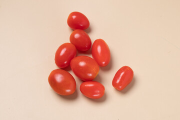 Fresh cherry tomatoes on brown background