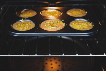 vegan savoury muffins with olives and nutritional yeast in the oven, healthy plant-based food