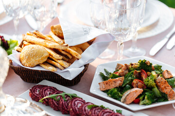 Served outdoor banquet table with assorted oriental appetizers