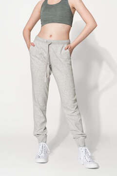 Sporty woman in sports bra and sweatpants for activewear photoshoot