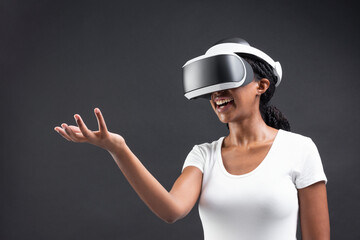 Woman using VR headset and reaching out a hand