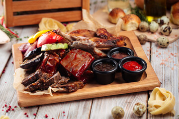 Assorted grilled meat and vegetables platter set with sauces