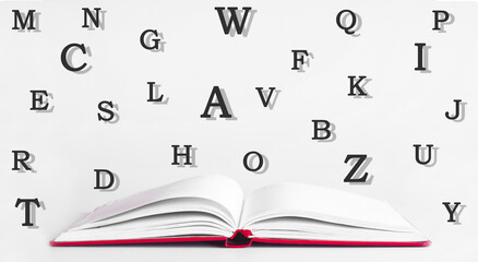 Open book. On a white background. The letters of the alphabet are scattered. Knowledge and wisdom concept