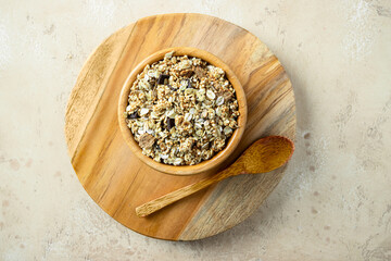 Wooden bowl with mix of unprocessed whole grains, chia, quinoa, nuts, seeds with chocolate .