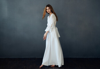 Fototapeta premium beautiful woman in white dress attractive look luxury charm gray background model