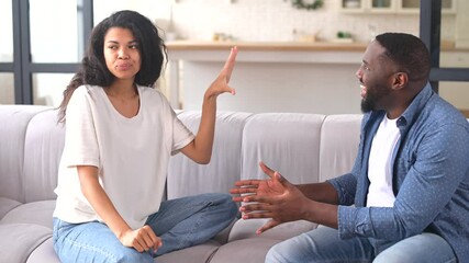 Multiracial couple is arguing at home. Angry young spouses screaming and misunderstanding to each other, African-American couple has relationships problem - Powered by Adobe