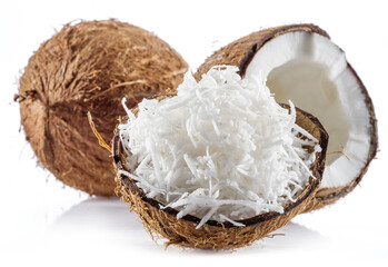Coconut fruit and shredded coconut flakes in the piece of shell isolated on white background.