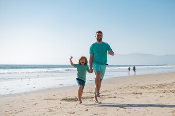 Father and son running on summer beach. Family travel, vacation, father's day concept.