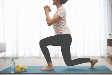 Training at Home. Sporty woman doing yoga plank while watching online tutorial on laptop exercising...