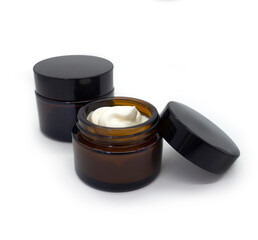 Mock up template with glass dark jar for cream and cosmetics. Container with lid isolated on white background. Element for advertising cosmetic and pharmaceutical products for health and beauty