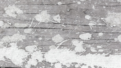 Drops and splashes from concrete on a wooden board