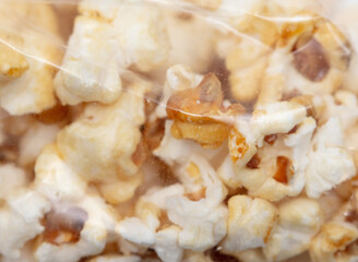 Popcorn in a plastic bag as a background.