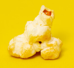 Close-up of popcorn on a yellow background.