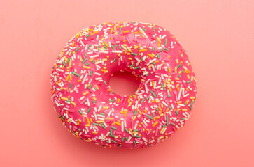 Red donut on a pink background.