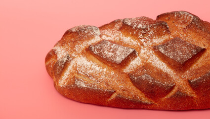 Fresh bread isolated on a pink background.