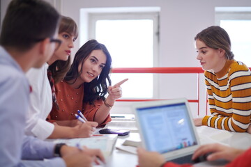 students group working on school project together on tablet computer at modern university