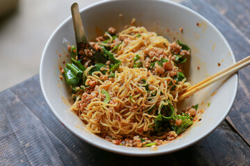 Dry noodles with minced pork in a bowl of noodles look delicious. Dry noodles with minced pork The Food of Thailand has a spicy flavor, Tom Yum seasoning.