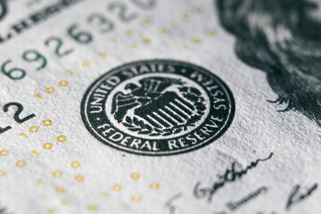 macro photo of federal reserve system symbol on one hundred dollar bill. shallow focus. close-up with fine and sharp texture - obrazy, fototapety, plakaty