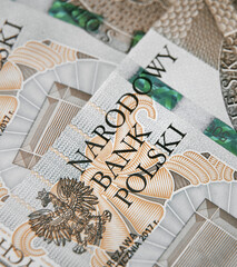 Close up on national polish bank of new Polish banknotes five hundred zloty. Macro photo of narodowy bank polski sign on PLN bill. Shallow focus. Close-up with fine and sharp texture - obrazy, fototapety, plakaty