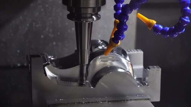 The  CNC  milling machine cutting  the mold parts by solid ball  end-mill tool. The hi-precision mold and die manufacturing concept by machining center.