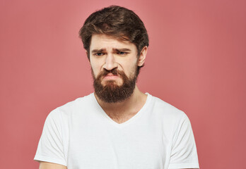 Obraz premium Man on pink background emotions model cropped view puzzled look sad face