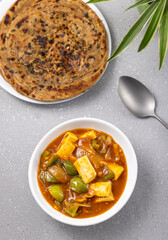 chilli paneer with lacha paratha served for the meal