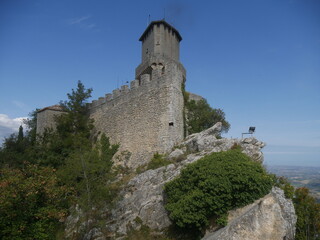 Fototapeta na wymiar San Marino, First Tower. Rear of the castle positioned on a rock overlooking the surrounding area and surrounded by mighty stone walls.