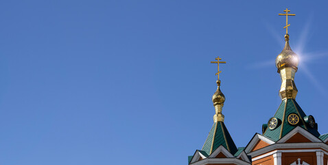 Fototapeta na wymiar Russian Christian Orthodox church with domes and a cross against the sky. Russian Orthodoxy and Christian Faith concept.