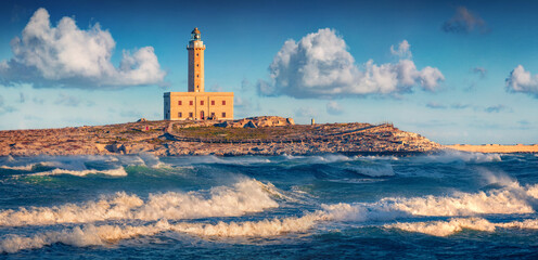 Stormy morning view of lighthouse in Vieste town. Breathtaking summer scene of Adriatic sea,...