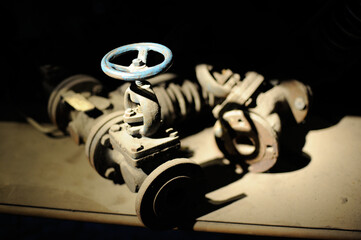 Old steel and iron heavy industrial metal parts and gear in an old factory or workshop for vintage technology used in metallurgy and metalworking and machine production