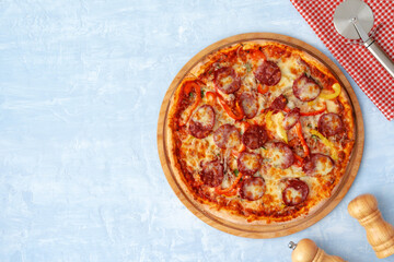 Delicious pizza with sausages on gray background