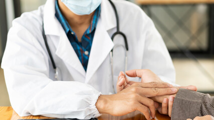 The doctor examines the pulse of mental health care concept by consulting a doctor in a health check-up clinic or hospital.