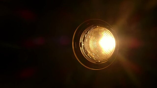 Video studio Fresnel lens spotlight on black background. lights  slowly turn on and off. Close up