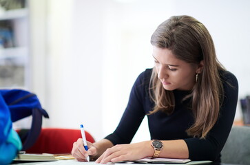 student taking notes for school class