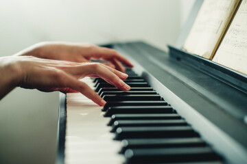 Fototapeta premium hands on the piano close-up