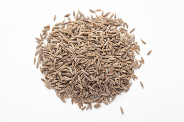 Macro close-up of Organic cumin seed (Cuminum cyminum) or jeera on white background. Pile of Indian Aromatic Spice. Top view