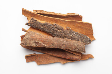 Macro close-up of Organic cinnamon ( Cinnamomum verum) or dalchini on white background. Pile of Indian Aromatic Spice. Top view