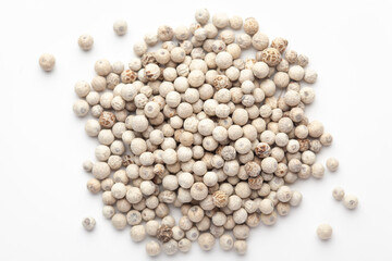 Macro close-up of Organic White peppercorns (Piper nigrum) on white background. Pile of Indian Aromatic Spice. Top view