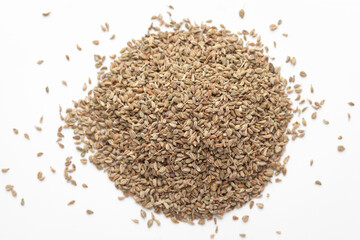 Macro close-up of Organic Ajwain seed (Trachyspermum ammi) or thymol seeds on white background. Pile of Indian Aromatic Spice. Top view