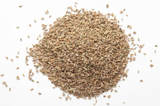 Macro close-up of Organic Ajwain seed (Trachyspermum ammi) or thymol seeds on white background. Pile of Indian Aromatic Spice. Top view