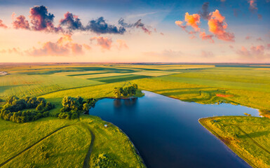 Beautiful summer scenery. Splendid summer sunrise on Stara Brykulia lake, Ternopil region. Breathtaking rural scene from flying drone of Ukrainian countryside. Traveling concept background.