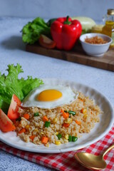 a plate of fried rice with vegetables and egg 